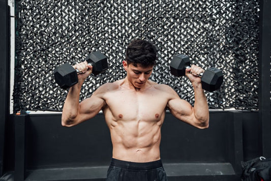Skinny guy flexing muscles after learning how to gain weight as a skinny guy through proper diet and training