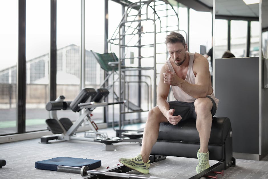 Person holding sore muscles after exercise, illustrating when to worry about workout soreness versus normal post-workout pain